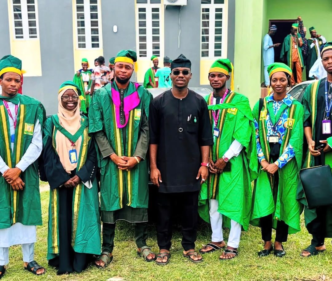 Akinmboni Marcus O. with fellow students in academic gowns at Kwara State University